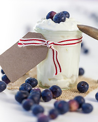 Image showing Jar of clotted cream or yogurt with blueberries