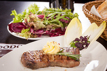 Image showing Grilled beef steak topped with butter and rosemary