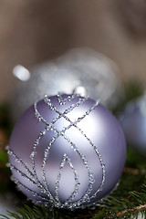 Image showing Silver Christmas ornaments in leaves