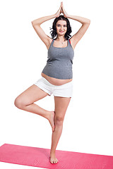 Image showing Active young pregnant woman doing yoga