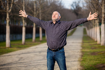 Image showing Middle-aged man enjoying the sunshine