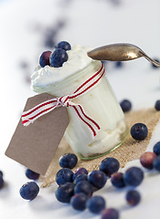 Image showing Jar of clotted cream or yogurt with blueberries