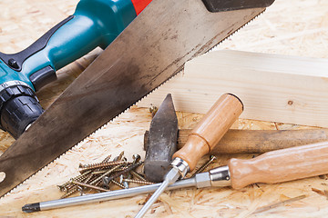 Image showing Drill with timber, screwdrivers and screws