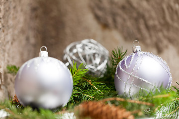 Image showing Silver Christmas ornaments in leaves