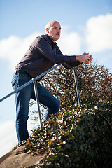 Image showing Thoughtful man sitting on a flight of steps