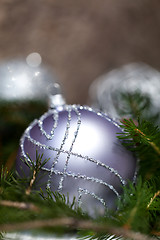 Image showing Silver Christmas ornaments in leaves