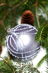 Image showing Silver Christmas ornaments in leaves