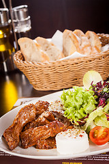 Image showing grilled beef stripes fresh salad and goat cheese