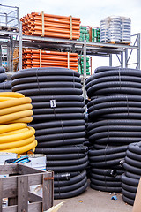 Image showing Rolls of plastic pipes in a warehouse yard