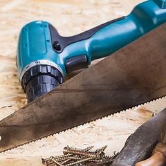 Image showing Drill with timber, screwdrivers and screws