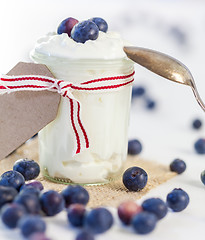 Image showing Jar of clotted cream or yogurt with blueberries