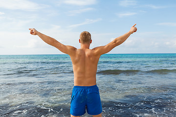 Image showing Man in blue swim shorts in the beach