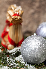 Image showing Silver Christmas bauble on a tree with snow