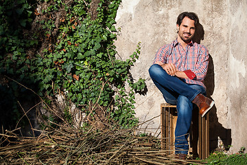 Image showing Male model sitting with legs crossed