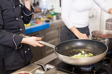 Image showing Chef or braising meat in a frying pan