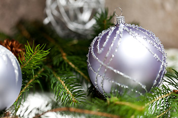 Image showing Silver Christmas ornaments in leaves