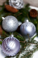 Image showing Silver Christmas ornaments in leaves