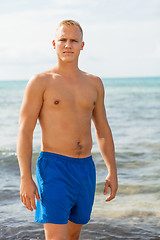 Image showing Man in blue swim shorts in the beach