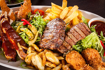 Image showing Platter of mixed meats, salad and French fries