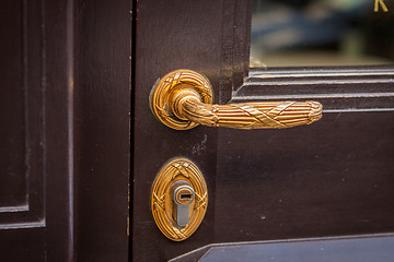 Image showing Brass door handle on a colorful blue door