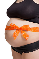 Image showing Pregnant woman wearing a bow on her belly