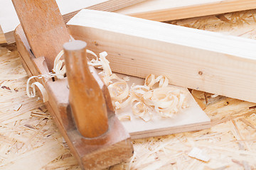 Image showing Handheld wood plane with wood shavings