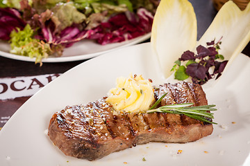 Image showing Grilled beef steak topped with butter and rosemary