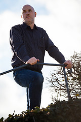 Image showing Thoughtful man sitting on a flight of steps