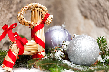 Image showing Silver Christmas bauble on a tree with snow