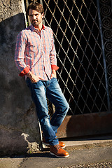 Image showing Male model leaning against wall