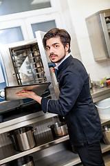 Image showing Chef cooking a vegetables stir fry over a hob