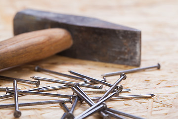 Image showing Mallet with nails and planks of new wood