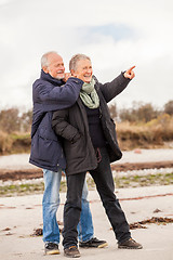 Image showing happy elderly senior couple walking on beach