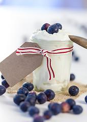 Image showing Jar of clotted cream or yogurt with blueberries