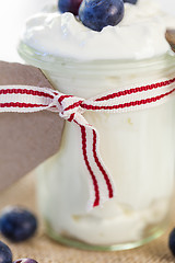 Image showing Jar of clotted cream or yogurt with blueberries