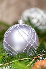 Image showing Silver Christmas ornaments in leaves