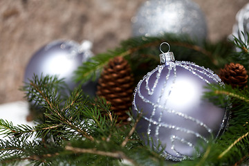 Image showing Silver Christmas ornaments in leaves