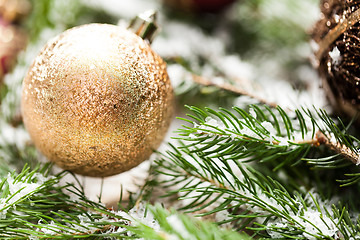 Image showing Gold Christmas ornament on leaves