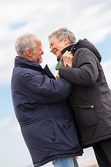 Image showing happy elderly senior couple walking on beach