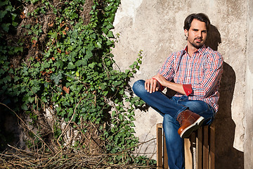 Image showing Male model sitting with legs crossed