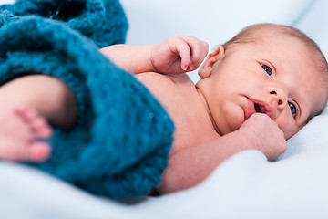 Image showing Small infant wrapped in knitted fabric