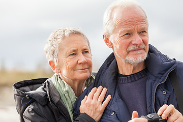 Image showing happy elderly senior couple walking on beach