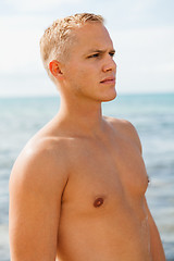 Image showing Man in blue swim shorts in the beach