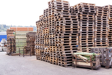 Image showing Stacks of old wooden pallets in a yard