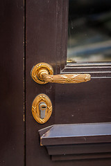 Image showing Brass door handle on a colorful blue door