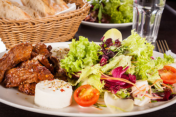 Image showing grilled beef stripes fresh salad and goat cheese