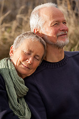 Image showing happy senior couple relaxing together in the sunshine