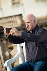 Image showing Man taking a photograph with his mobile