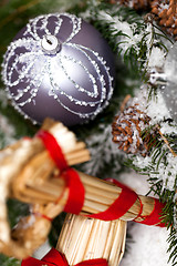 Image showing Silver Christmas bauble on a tree with snow