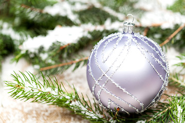 Image showing Silver Christmas ornaments in leaves